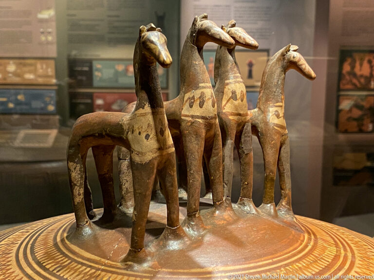 Four modeled horses stand on the decorated lid of a large Attic Geometric pyxis dated 760–750 BC.