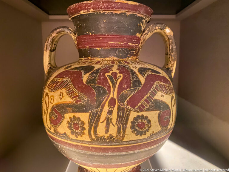 Two-handled painted vessel with large birds, rosettes, and a central stylized motif.