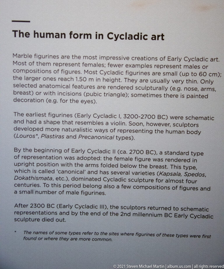 Museum text panel titled “Marble figurine form in Cycladic art,” with paragraphs explaining Early Cycladic figure types.
