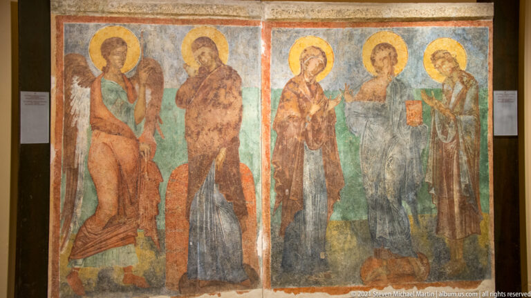 Two conserved fresco panels with groups of haloed saints in long robes against green and ocher backgrounds.