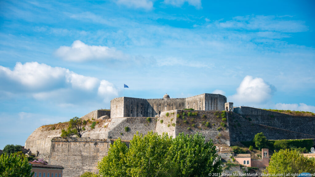 New Fortress of Corfu rising above the town with massive stone bastions, sloping revetments, and upper defenses.