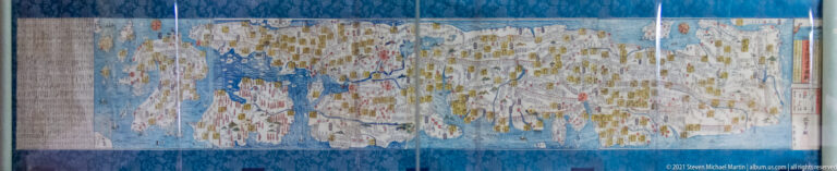 Large museum map of the Japanese archipelago with dense place labels and markings surrounded by blue sea.