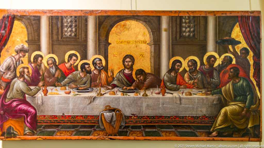 Last Supper icon with Christ and the apostles seated around a long table beneath architectural arches.