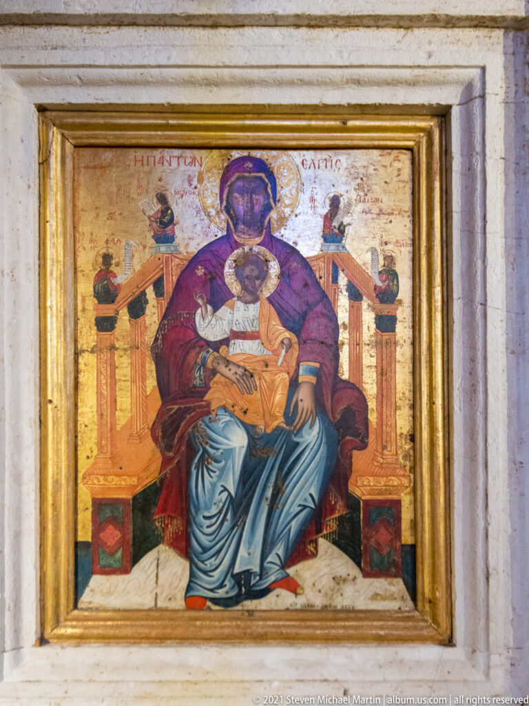 Early-17th-century Virgin Enthroned icon by Michail Avramis, with the Christ Child and small angels against a gold ground.