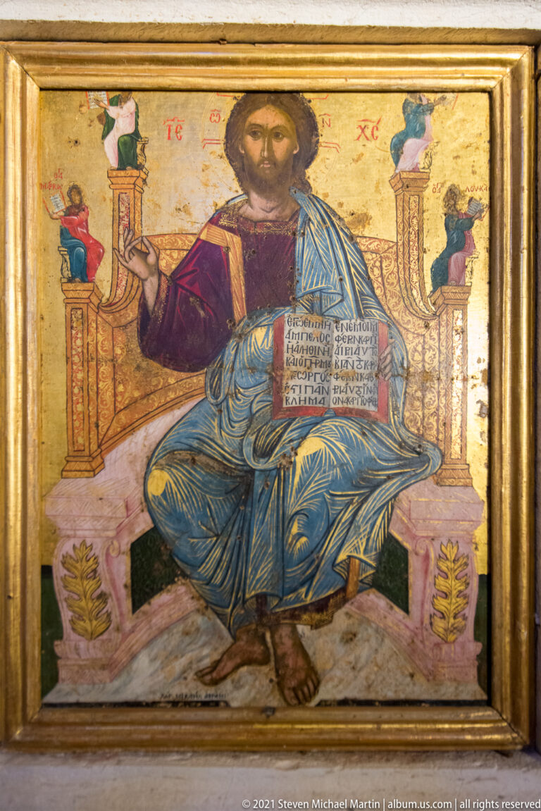 Early-17th-century enthroned Christ Pantocrator icon by Michail Avramis, blessing and holding an open Gospel against a gold ground.
