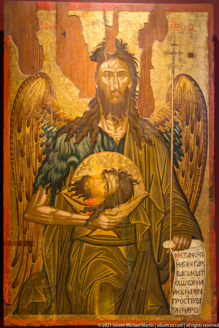 Early-17th-century Saint John the Baptist icon by Michail Avramis, shown winged with staff and severed head on a platter.