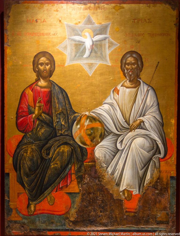 Icon of Christ and an elderly God the Father seated together beneath a radiant dove representing the Holy Spirit.