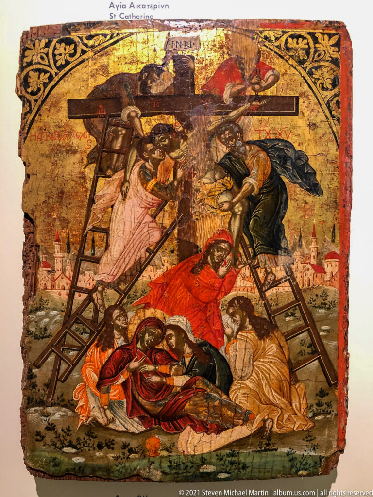 Passion icon with Christ lowered from the Cross on ladders while mourners gather around his body below.