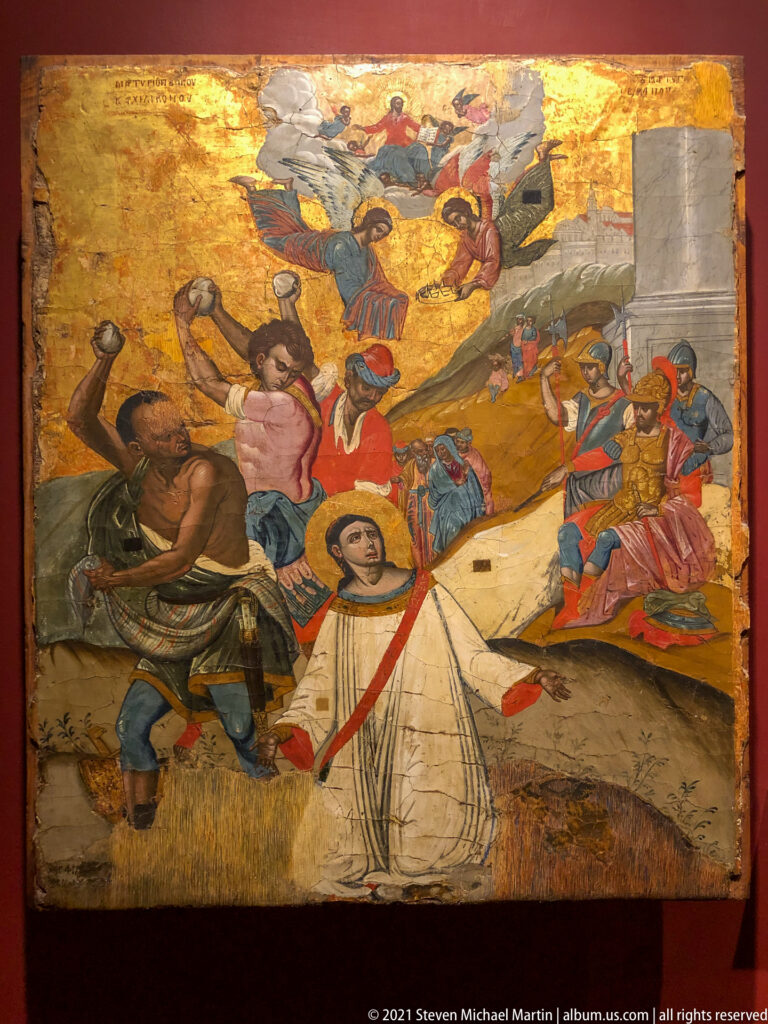 Haloed bound saint in a pale robe surrounded by armed executioners and soldiers, with angels appearing above.