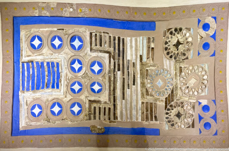 Close detail of the Knossos Draughtboard showing blue circular fields, striped compartments, rosettes, and precious-material inlay.