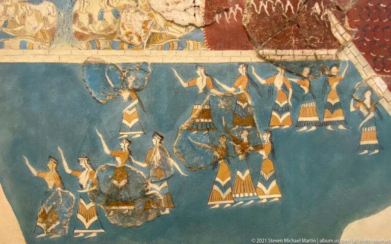Reconstructed Sacred Grove and Dance Fresco with numerous women in patterned skirts moving across a blue ground.