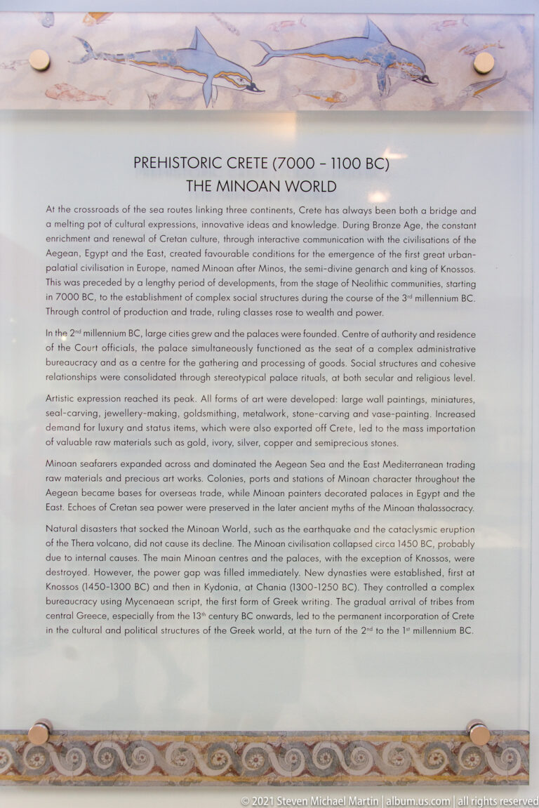 Museum panel headed “Pre-historic Crete (7000–1100 BC): The Minoan World,” with explanatory text.