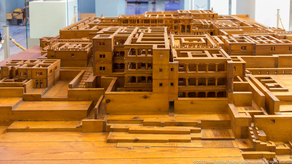 Wooden scale model of a multi-level Minoan palace complex with courts, stairways, rooms, and colonnaded façades.