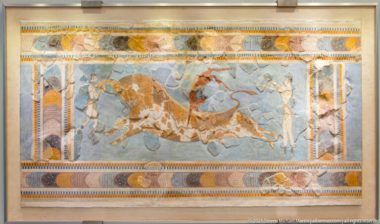 Reconstructed Bull-Leaping Fresco from Knossos with a charging bull and three athletic figures.