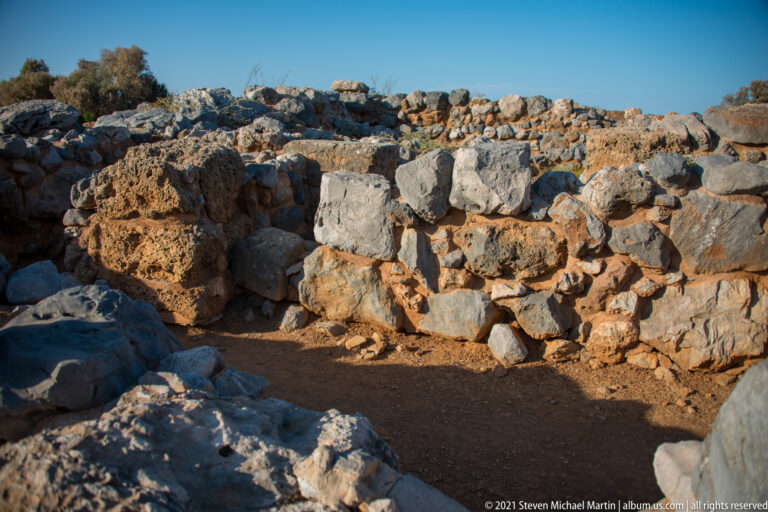 Close view of rough rubble masonry built from large porous stones and smaller irregular blocks.