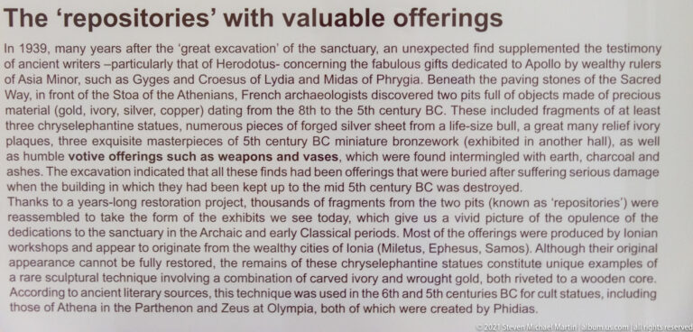 English museum panel titled “The ‘treasuries’ with valuable offerings,” describing precious finds from Delphi.