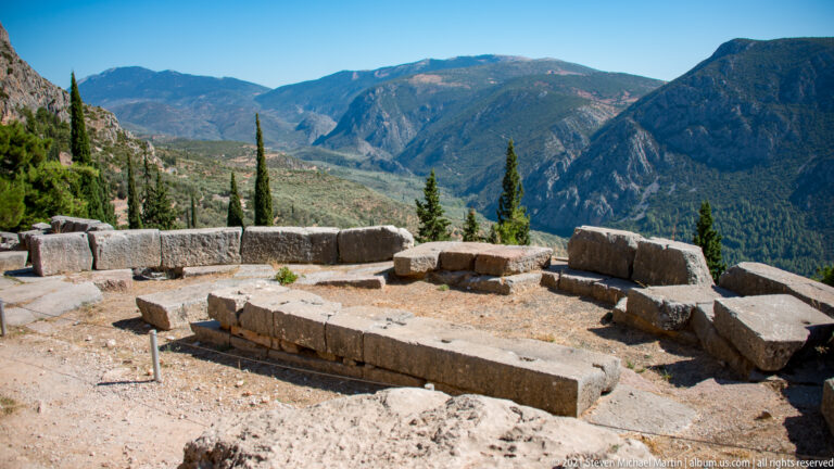 Rectangular ancient stone foundation on a terrace overlooking the broad mountain valley below Delphi.