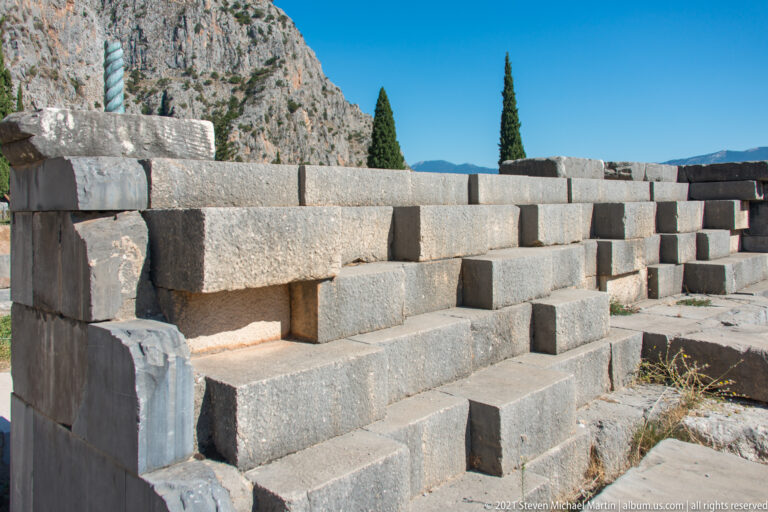 Close oblique view of a massive ancient wall built from large irregular fitted stone blocks at Delphi.