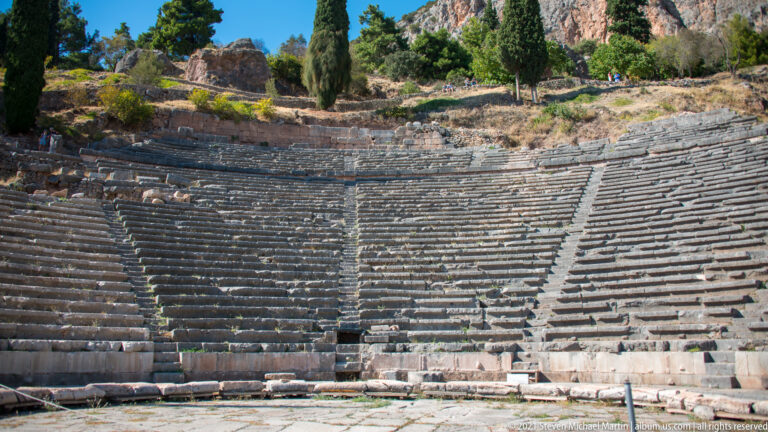 Semicircular tiers of stone seating and stairways in the ancient Theatre of Delphi.