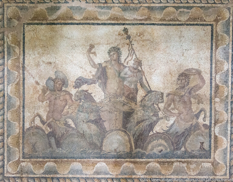Central panel of the Dionysus mosaic showing the god riding in a chariot drawn by panthers, accompanied by Silenus and centaurs.