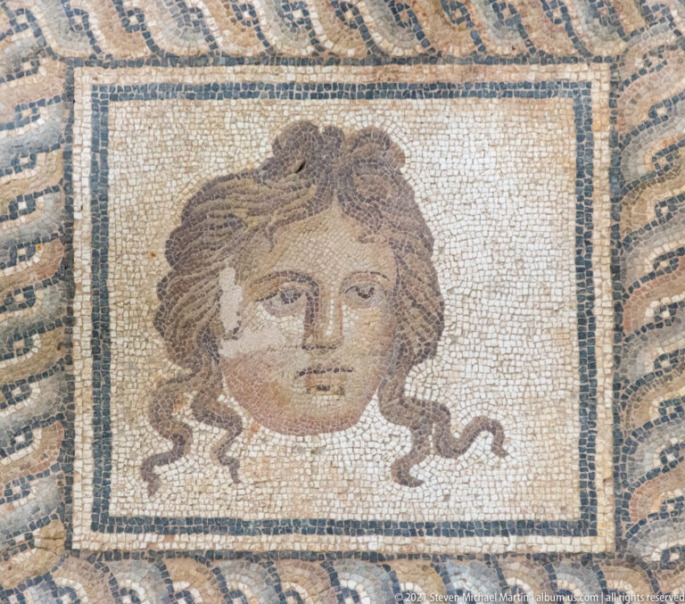 Framed mosaic head from the theatrical imagery surrounding the Epiphany of Dionysus pavement at Dion.
