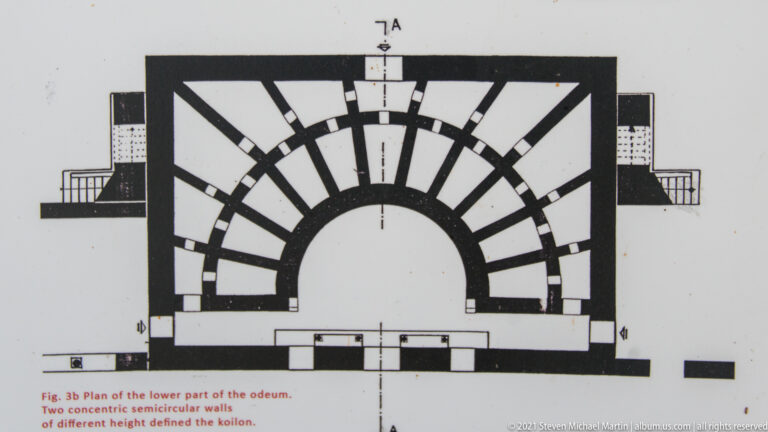 Architectural plan of the odeum showing semicircular seating, radial stairs, orchestra, enclosing walls, and entrances.