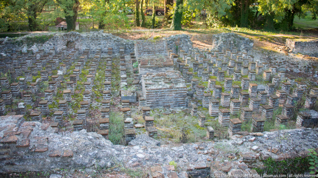 Wide view of brick hypocaust pilae beneath the former floor of the Great Thermae at ancient Dion.