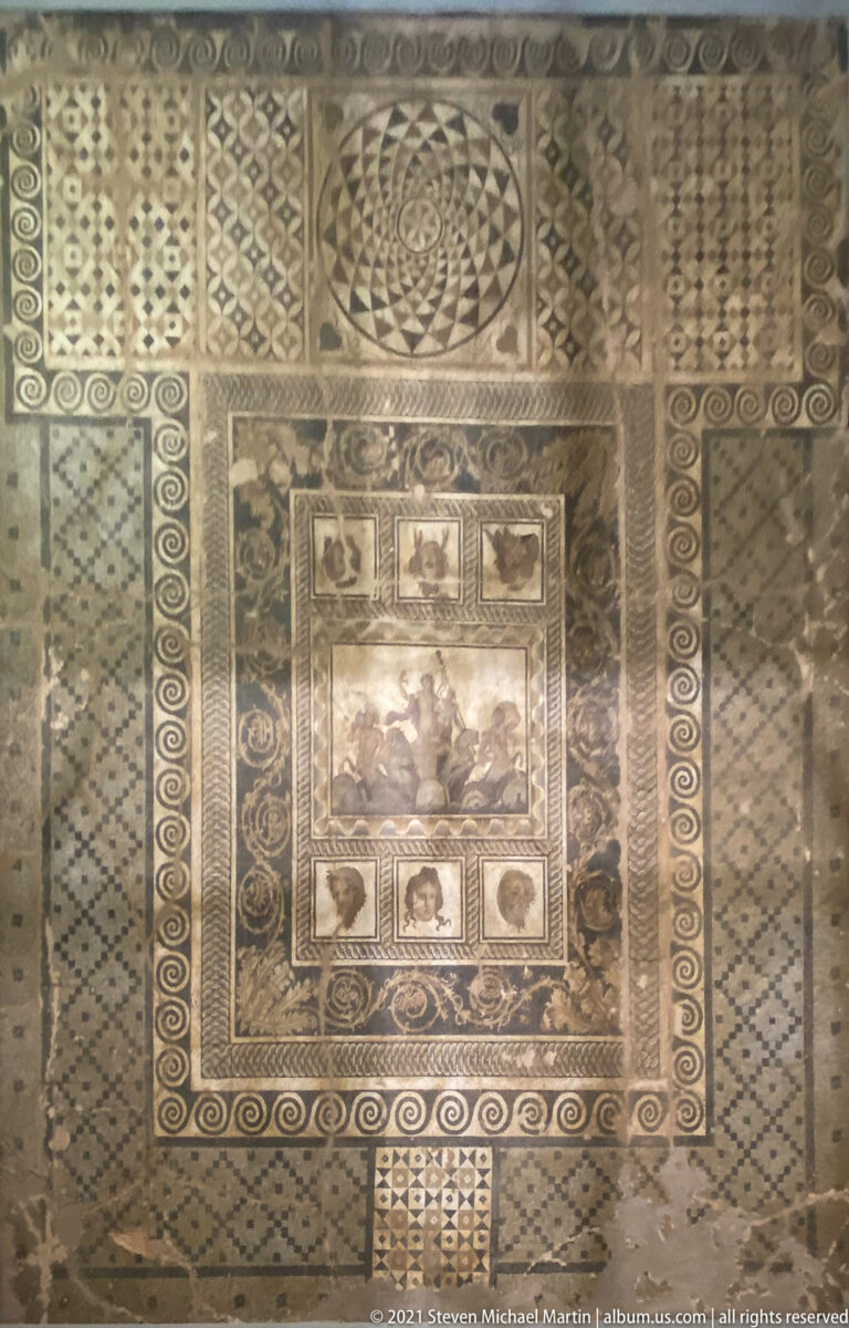Full second-century AD Mosaic of the Epiphany of Dionysus with central chariot scene, theatrical masks, and extensive geometric borders.