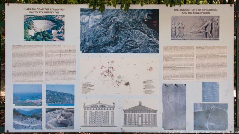 Large outdoor information panel with maps, plans, photographs, reconstruction drawings, and text about ancient Epidaurus.