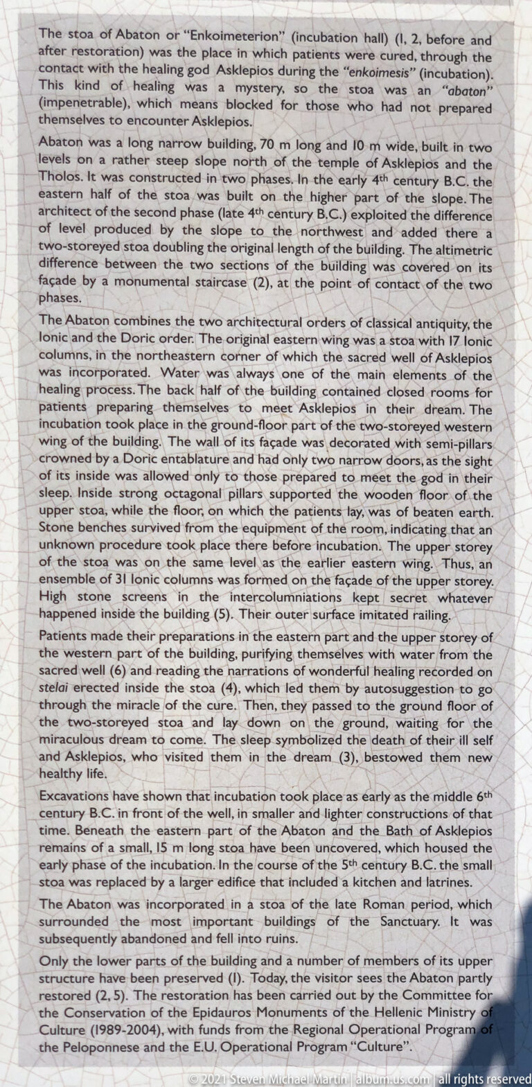 Close view of interpretive text describing the Enkoimeterion or Abaton, its construction phases, architecture, and healing use.