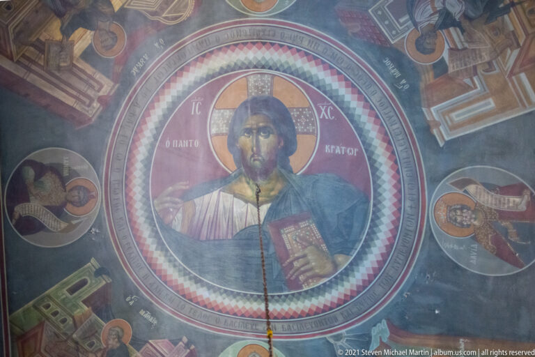 Ceiling mural of Christ Pantocrator blessing and holding a Gospel book within a large circular medallion.