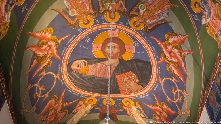 Ceiling painting of Christ Pantocrator in a round medallion, surrounded by angels and other sacred figures.