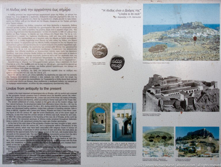 Interpretive panel about Lindos history with bilingual text, coins, photographs and an acropolis reconstruction.