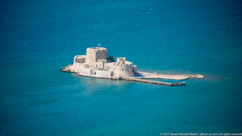 Bourtzi Fortress occupying a small islet in the blue waters of Nafplio harbor.