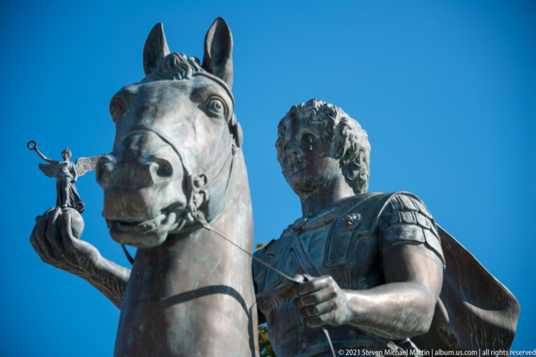 Close low-angle detail of Alexander the Great, his horse, armor, reins, and the winged Nike in his hand.