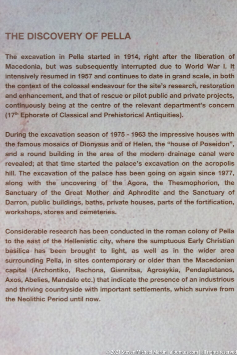 Close view of a museum text panel headed “History of Pella,” describing excavations and archaeological research at the site.