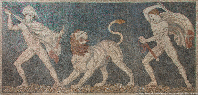 Pebble mosaic detail with two human hunters attacking a lion at the center.