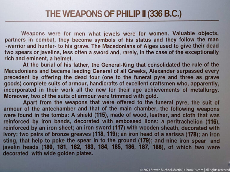 Museum panel titled “The Weapons of Philip II (336 B.C.)” interpreting arms recovered from the royal burial.