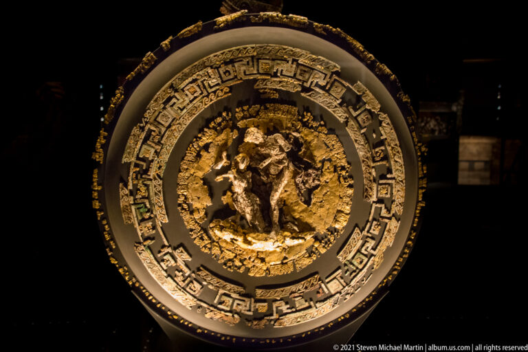 Large ceremonial shield from the Tomb of Philip II with concentric geometric ornament and a central figural relief.