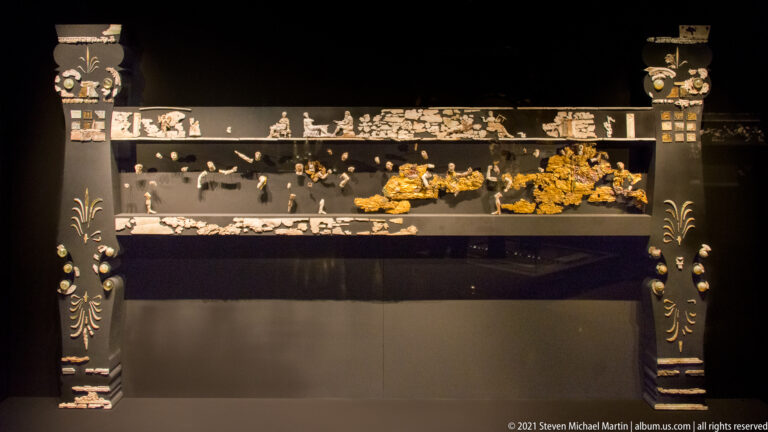 Full-width reconstruction of the chryselephantine funerary couch from the Tomb of Philip II with surviving ivory and gilded decoration.