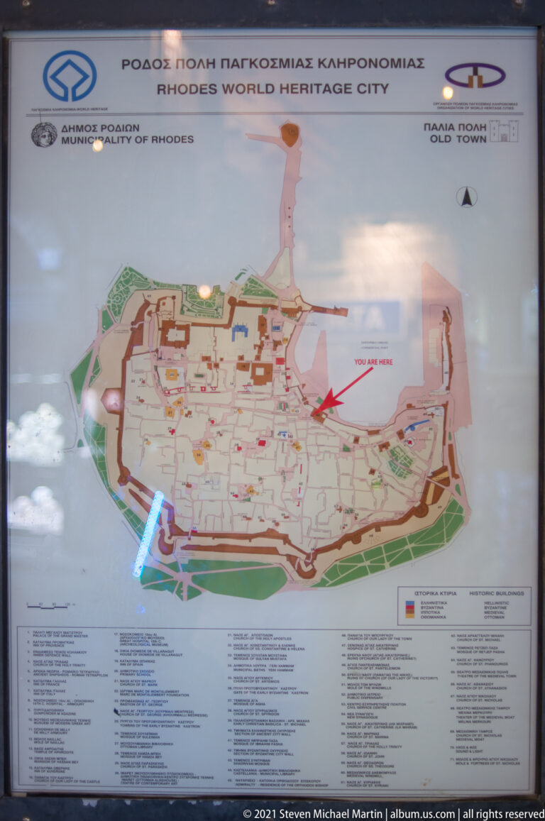 Mounted visitor map showing the fortified Medieval City of Rhodes and its streets, gates, and landmarks.