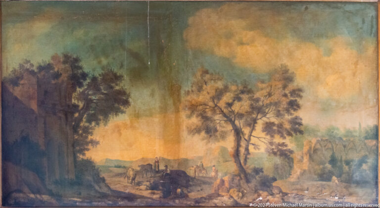 Large landscape painting with tall trees, glowing clouds, distant figures, and a shadowed foreground clearing.