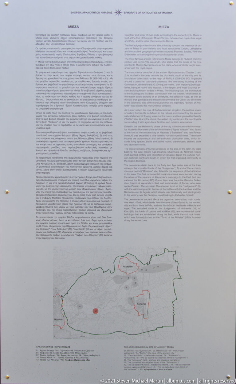 Mounted bilingual information panel with dense text above a green-outlined archaeological map marked with red site areas.