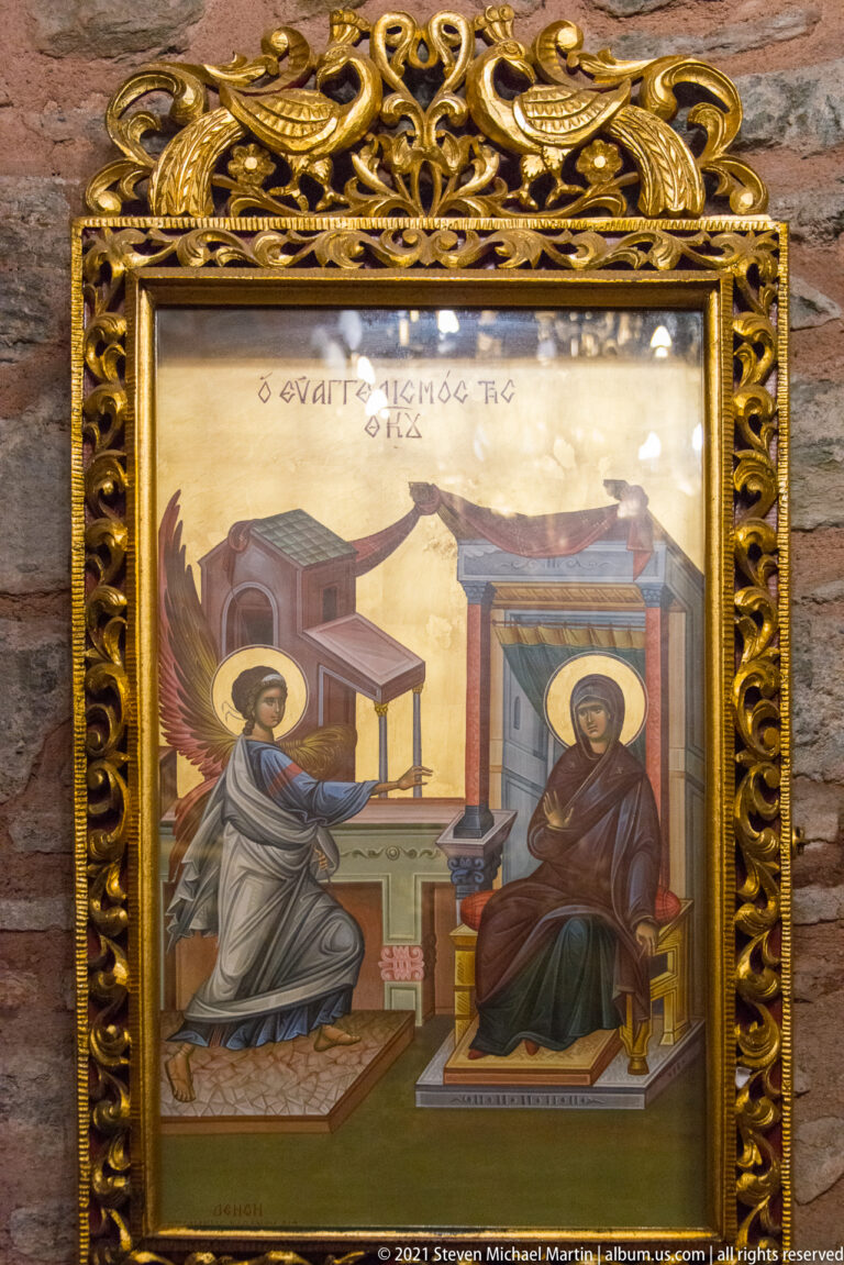 Framed Orthodox icon of the Annunciation with Gabriel facing the seated Virgin Mary.
