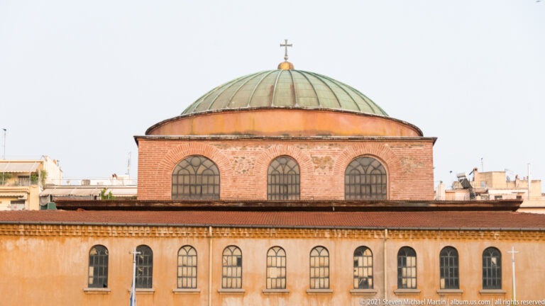Close exterior view of Hagia Sophia’s low dome and rows of arched windows.