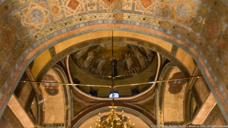 Upward view of decorated arches and the base of the central dome inside Hagia Sophia.