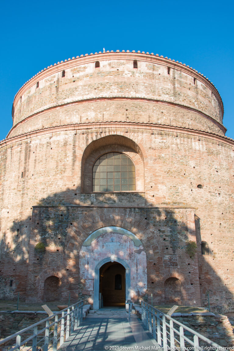 Front exterior of the brick Rotunda of Galerius with arched window, entrance, and access ramp.