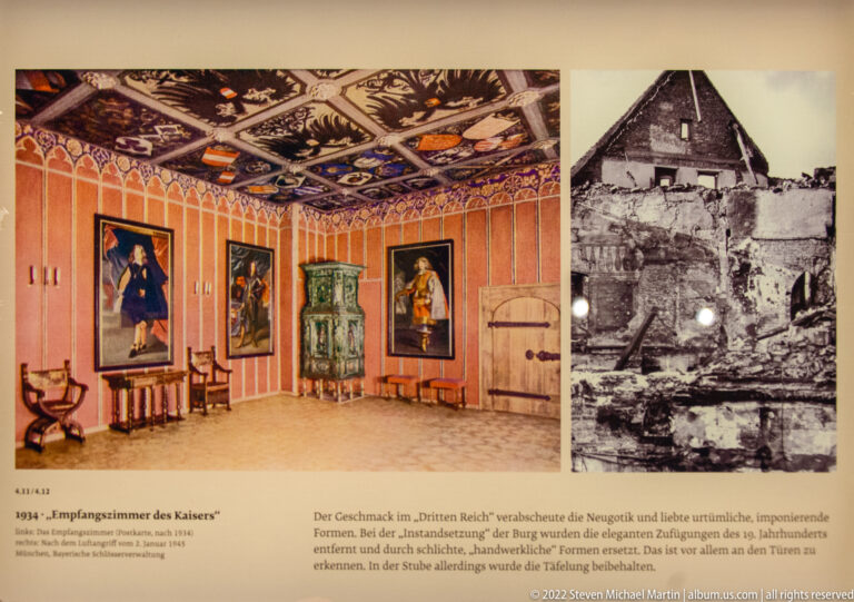 Museum panel with color reconstruction of an ornate room beside a black-and-white photograph of a damaged interior.