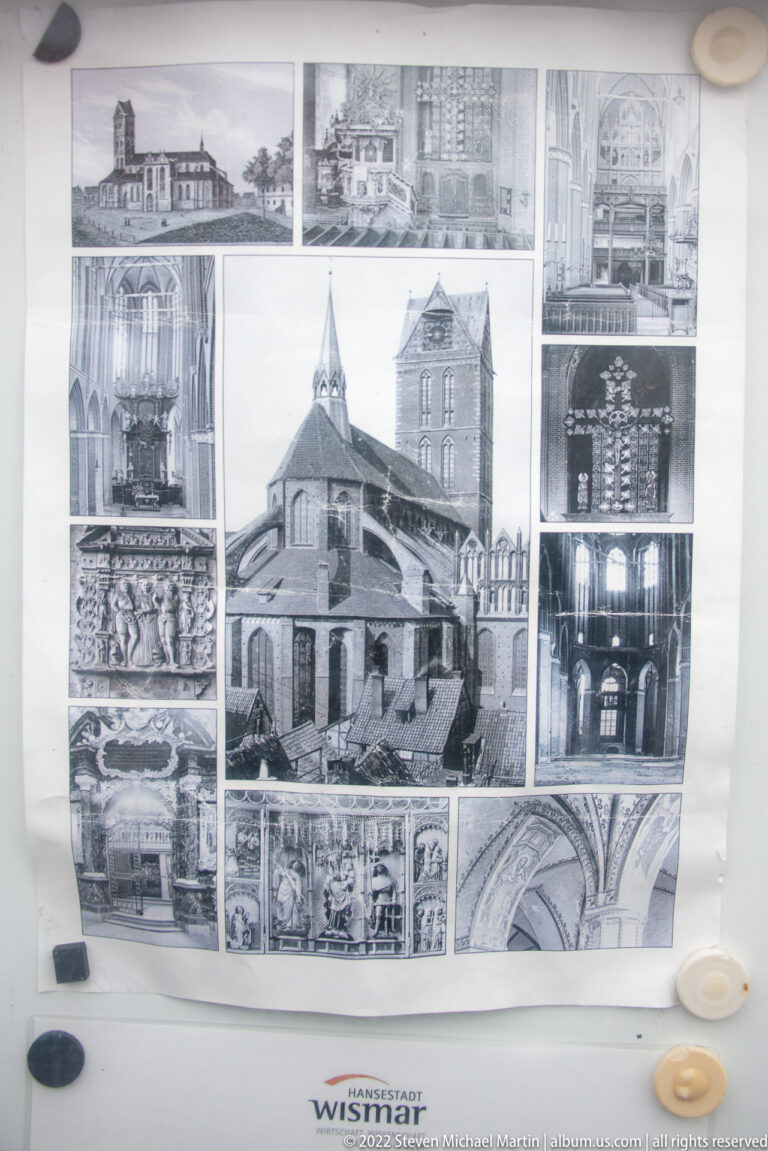 Display board with black-and-white archival photographs of a historic church or tower and architectural details.