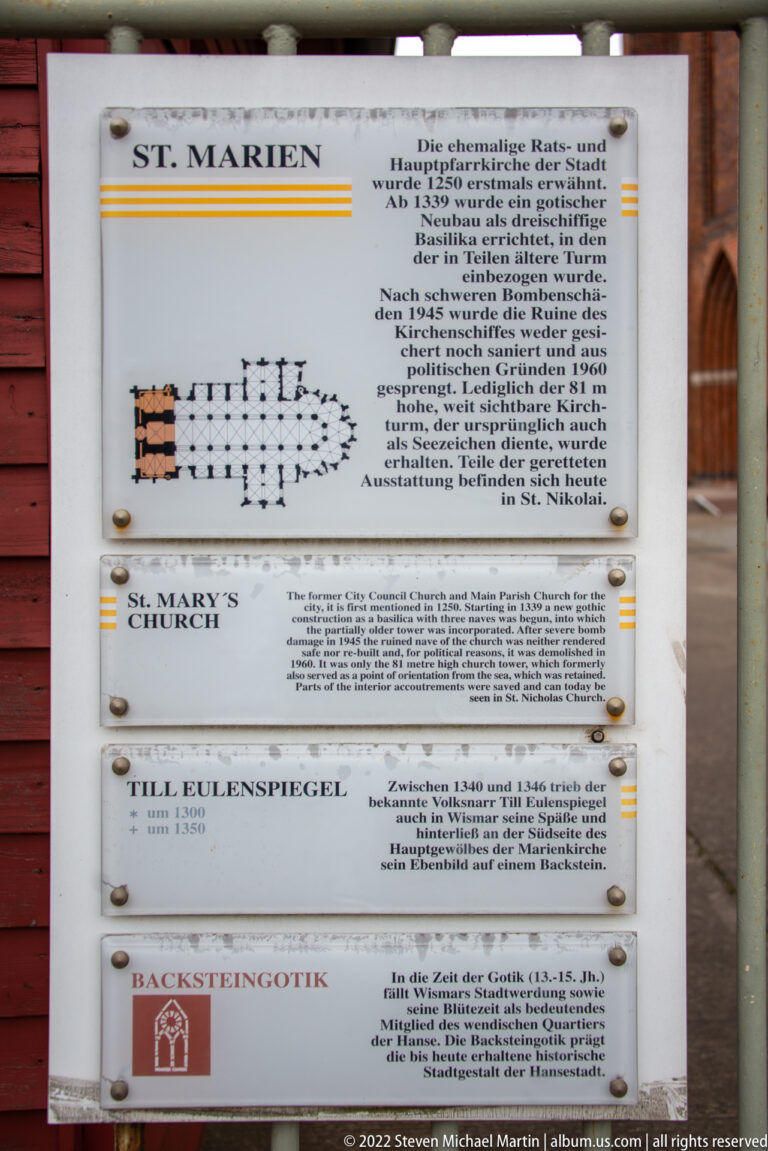 Outdoor heritage sign with a church plan, German and English text, and references to Brick Gothic.